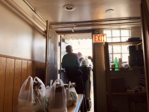 Carmen Rance distributes meals to do from the back door of the food pantry at San Lucas United Methodist Church in Humboldt Park.
